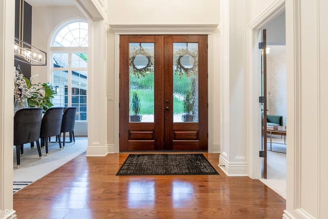 11911 W Grandview Dr, Columbus, IN 47201 - entryway with wood finished floors, french doors, baseboards, and ornate columns