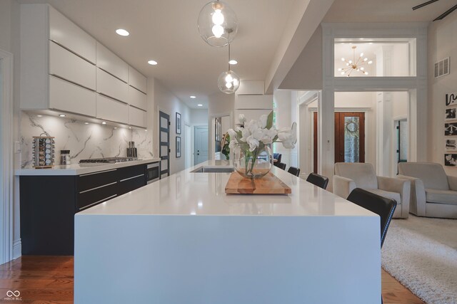11911 W Grandview Dr, Columbus, IN 47201 - kitchen with modern cabinets, open floor plan, light countertops, wood finished floors, and white cabinetry