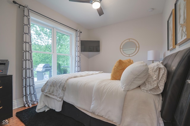 11911 W Grandview Dr, Columbus, IN 47201 - bedroom featuring wood finished floors, a ceiling fan, and baseboards