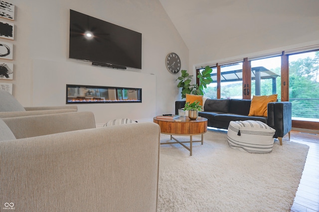 11911 W Grandview Dr, Columbus, IN 47201 - living area featuring high vaulted ceiling, healthy amount of natural light, and wood finished floors