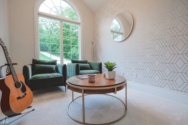 11911 W Grandview Dr, Columbus, IN 47201 - living area with carpet, vaulted ceiling, an accent wall, and wallpapered walls