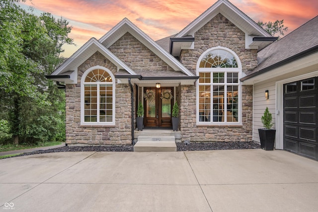 11911 W Grandview Dr, Columbus, IN 47201 - doorway to property with stone siding, french doors, and a garage