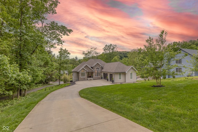 11911 W Grandview Dr, Columbus, IN 47201 - view of front facade featuring concrete driveway, a front yard, an attached garage, and stone siding