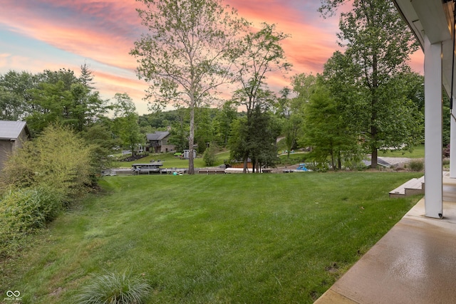 11911 W Grandview Dr, Columbus, IN 47201 - yard at dusk featuring a lawn and view of scattered trees