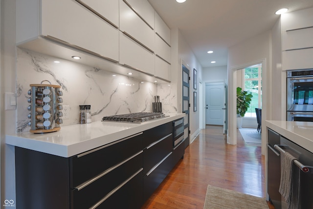 11911 W Grandview Dr, Columbus, IN 47201 - kitchen featuring dark cabinets, stainless steel appliances, wood finished floors, white cabinets, and modern cabinets