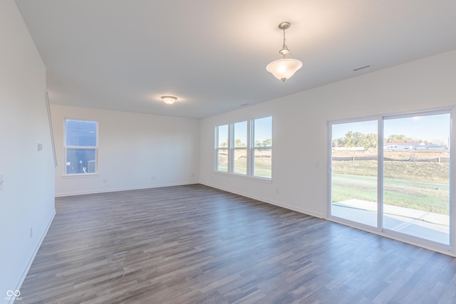 1108 Bevy Blvd, Danville, IN 46122 - empty room with dark wood-style flooring, baseboards, and plenty of natural light