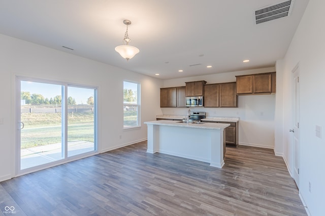 1108 Bevy Blvd, Danville, IN 46122 - kitchen with stainless steel appliances, light countertops, recessed lighting, wood finished floors, and baseboards