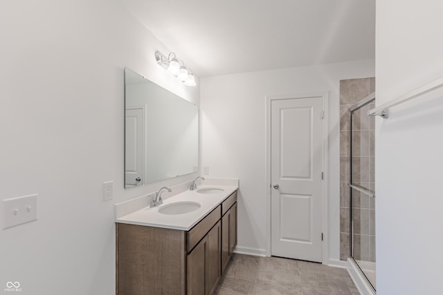 1108 Bevy Blvd, Danville, IN 46122 - bathroom featuring tiled shower, double vanity, and baseboards