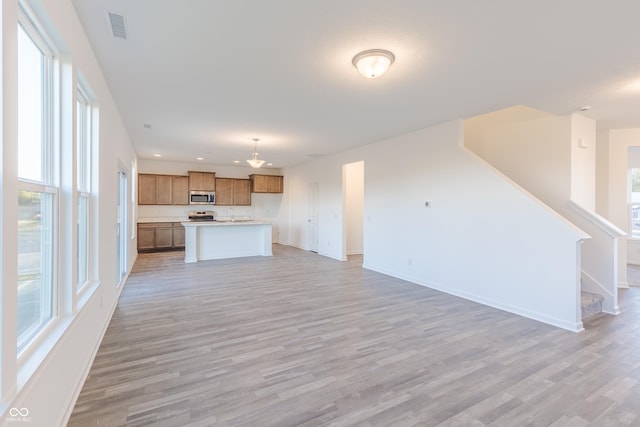1108 Bevy Blvd, Danville, IN 46122 - unfurnished living room featuring light wood-type flooring, baseboards, stairs, and recessed lighting