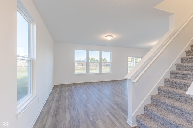1108 Bevy Blvd, Danville, IN 46122 - unfurnished living room featuring stairs, wood finished floors, and baseboards