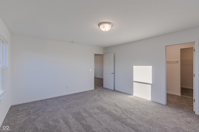 1108 Bevy Blvd, Danville, IN 46122 - unfurnished bedroom with carpet flooring, a walk in closet, baseboards, and a closet