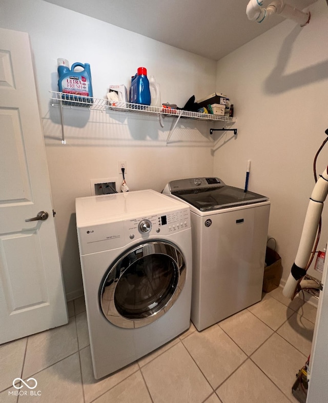 808 Capricorn Dr, Franklin, IN 46131 - laundry room with washer and clothes dryer and light tile patterned flooring