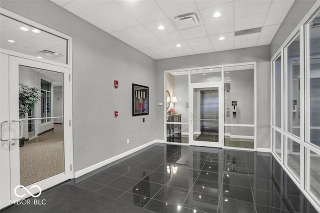 435 Virginia Ave Unit 108, Indianapolis, IN 46203 - hallway featuring baseboards, a drop ceiling, recessed lighting, elevator, and french doors