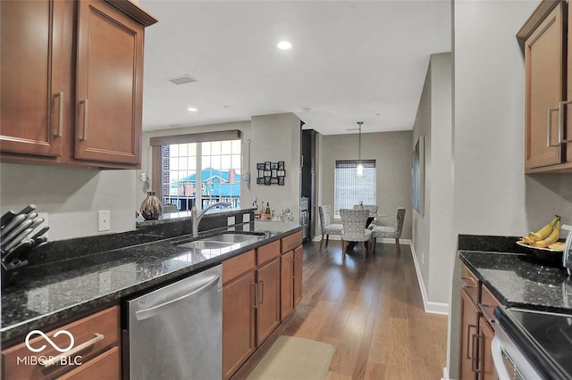 435 Virginia Ave Unit 108, Indianapolis, IN 46203 - kitchen with stainless steel dishwasher, a sink, brown cabinetry, wood finished floors, and recessed lighting