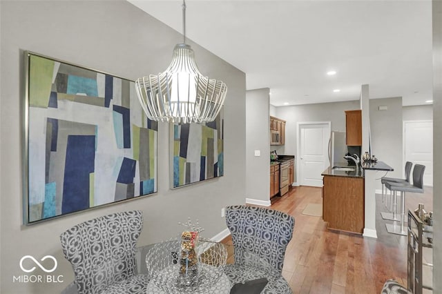435 Virginia Ave Unit 108, Indianapolis, IN 46203 - dining area with wood finished floors, baseboards, recessed lighting, and a chandelier