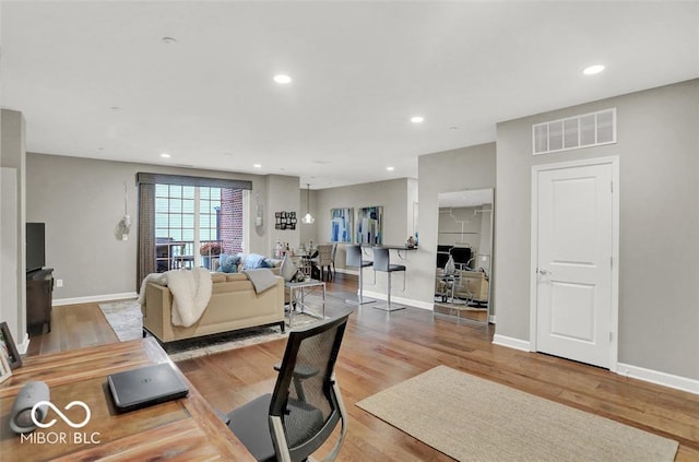 435 Virginia Ave Unit 108, Indianapolis, IN 46203 - living area featuring wood finished floors, baseboards, and recessed lighting