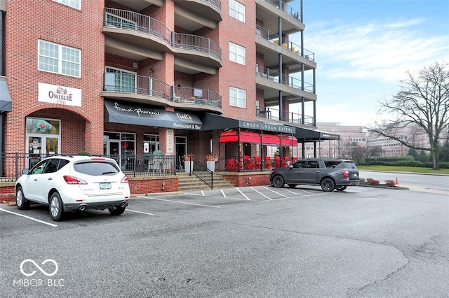 435 Virginia Ave Unit 108, Indianapolis, IN 46203 - view of apartment building / complex featuring uncovered parking and view of commercial area
