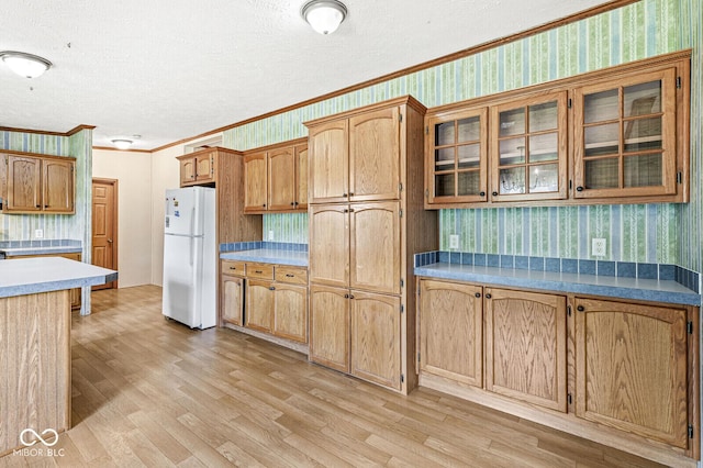 5428 S 525 W, Williamsport, IN 47993 - kitchen with freestanding refrigerator, wallpapered walls, a textured ceiling, crown molding, and light wood finished floors