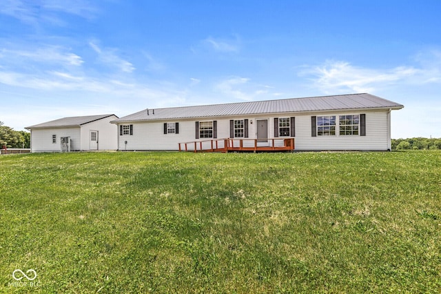 5428 S 525 W, Williamsport, IN 47993 - rear view of house with a wooden deck, a lawn, and metal roof