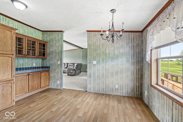 5428 S 525 W, Williamsport, IN 47993 - unfurnished dining area featuring wallpapered walls, ornamental molding, a textured ceiling, a chandelier, and light wood-style floors