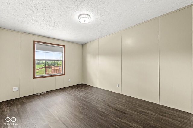 5428 S 525 W, Williamsport, IN 47993 - empty room featuring a decorative wall, wood finished floors, and a textured ceiling