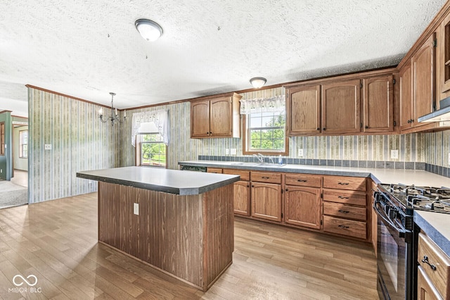 5428 S 525 W, Williamsport, IN 47993 - kitchen featuring light wood-style floors, black gas range oven, a sink, a kitchen island, and a textured ceiling