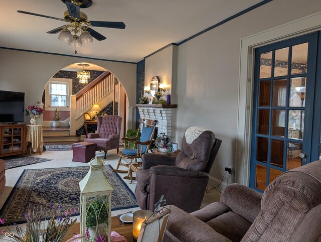 150 W Walnut St, North Vernon, IN 47265 - living area with arched walkways, a fireplace, ceiling fan, a chandelier, and baseboards