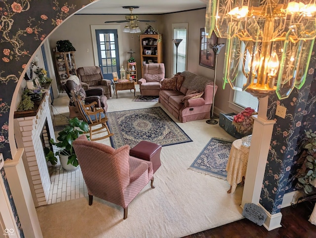 150 W Walnut St, North Vernon, IN 47265 - carpeted living area with a chandelier, plenty of natural light, ceiling fan, and arched walkways