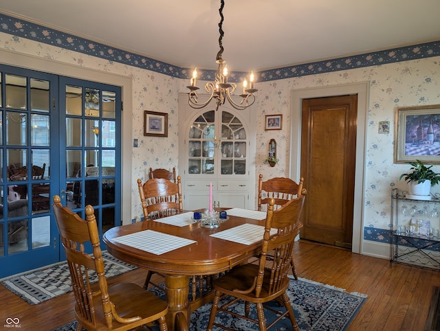 150 W Walnut St, North Vernon, IN 47265 - dining room featuring hardwood / wood-style flooring, wallpapered walls, a chandelier, and baseboards