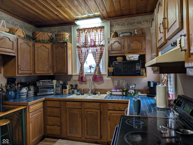 150 W Walnut St, North Vernon, IN 47265 - kitchen with black appliances, a sink, tile countertops, wallpapered walls, and wood ceiling