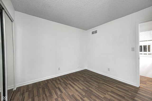 5097 Vantage Point Rd Unit B 2, Avon, IN 46123 - spare room with dark wood-style floors, baseboards, and a textured ceiling