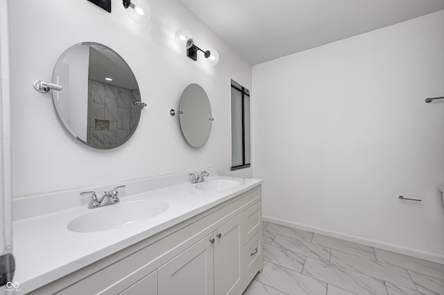 5097 Vantage Point Rd Unit B 2, Avon, IN 46123 - bathroom with marble look tiles, double vanity, baseboards, and a shower