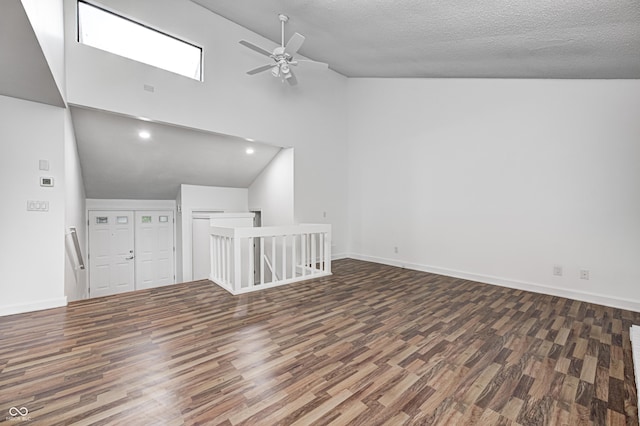 5097 Vantage Point Rd Unit B 2, Avon, IN 46123 - unfurnished living room with wood finished floors, ceiling fan, baseboards, high vaulted ceiling, and a textured ceiling