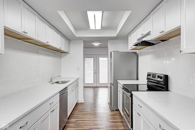 5097 Vantage Point Rd Unit B 2, Avon, IN 46123 - kitchen featuring appliances with stainless steel finishes, a sink, a raised ceiling, under cabinet range hood, and backsplash
