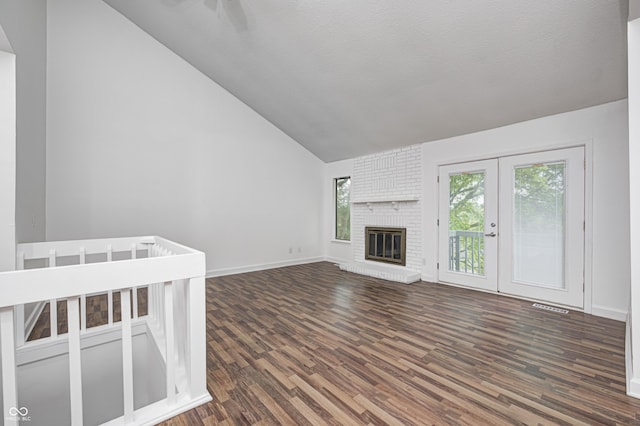 5097 Vantage Point Rd Unit B 2, Avon, IN 46123 - unfurnished living room featuring dark wood finished floors, lofted ceiling, baseboards, and a brick fireplace