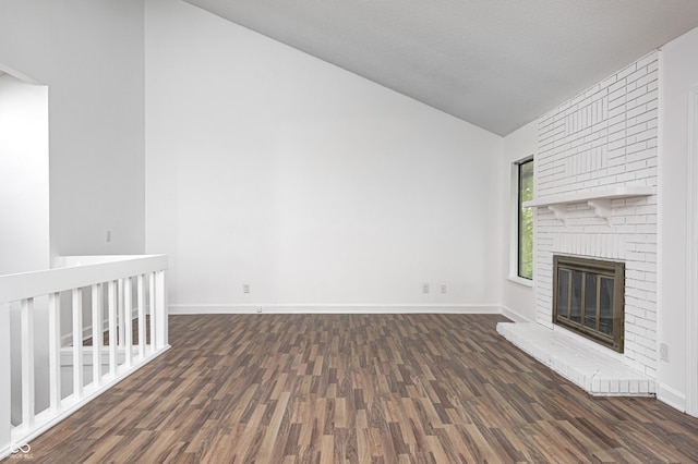 5097 Vantage Point Rd Unit B 2, Avon, IN 46123 - unfurnished living room with lofted ceiling, dark wood-style floors, a brick fireplace, and baseboards