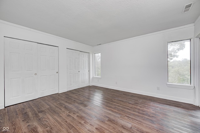 5097 Vantage Point Rd Unit B 2, Avon, IN 46123 - unfurnished bedroom with two closets, multiple windows, ornamental molding, and wood finished floors