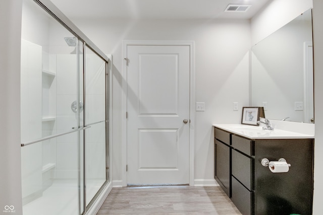 9829 Hulton Rd, Pendleton, IN 46064 - bathroom with a stall shower, vanity, wood finished floors, and baseboards