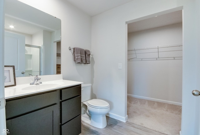 9829 Hulton Rd, Pendleton, IN 46064 - bathroom featuring a spacious closet, vanity, toilet, and an enclosed shower
