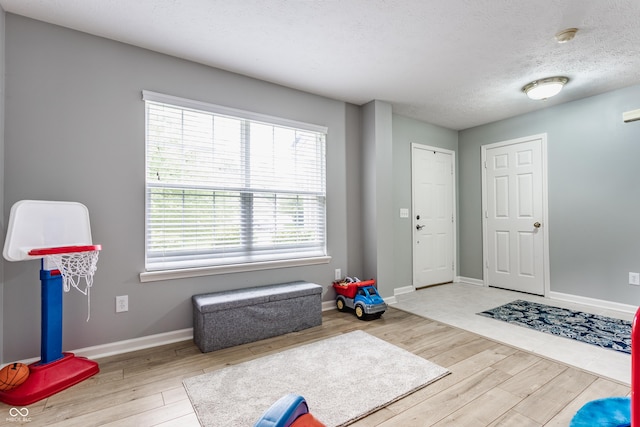 11919 Gatwick View Dr, Fishers, IN 46037 - workout area with wood finished floors, baseboards, and a textured ceiling