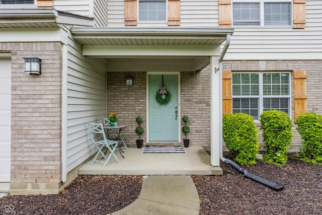 11919 Gatwick View Dr, Fishers, IN 46037 - doorway to property featuring brick siding and a porch
