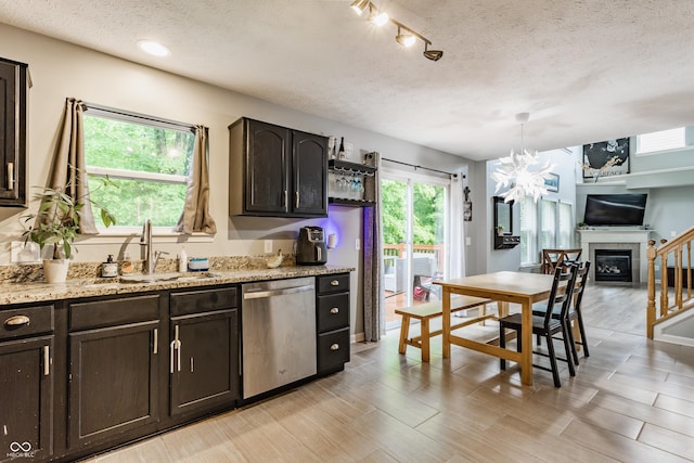11919 Gatwick View Dr, Fishers, IN 46037 - kitchen featuring dishwasher, a sink, a textured ceiling, dark brown cabinetry, and a chandelier