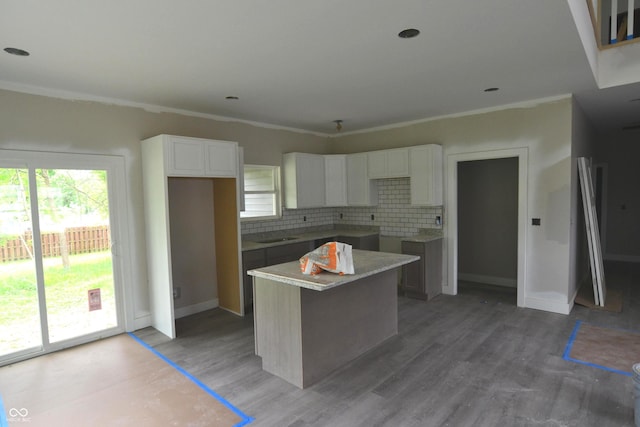 262 Jefferson Vly, Coatesville, IN 46121 - kitchen featuring a kitchen island, decorative backsplash, white cabinets, light wood-style flooring, and crown molding