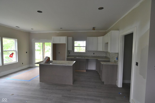262 Jefferson Vly, Coatesville, IN 46121 - kitchen featuring a center island, tasteful backsplash, white cabinets, light wood-style flooring, and crown molding
