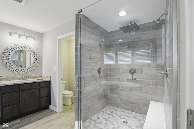 2485 Alexandra Dr, Carmel, IN 46074 - full bath with a shower stall, toilet, vanity, wood finish floors, and baseboards