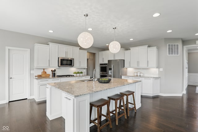 2485 Alexandra Dr, Carmel, IN 46074 - kitchen with appliances with stainless steel finishes, an island with sink, a sink, recessed lighting, and dark wood-style floors
