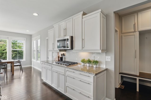 2485 Alexandra Dr, Carmel, IN 46074 - kitchen with stainless steel appliances, light stone countertops, tasteful backsplash, baseboards, and recessed lighting
