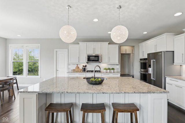 2485 Alexandra Dr, Carmel, IN 46074 - kitchen with stainless steel appliances, a chandelier, recessed lighting, and white cabinets