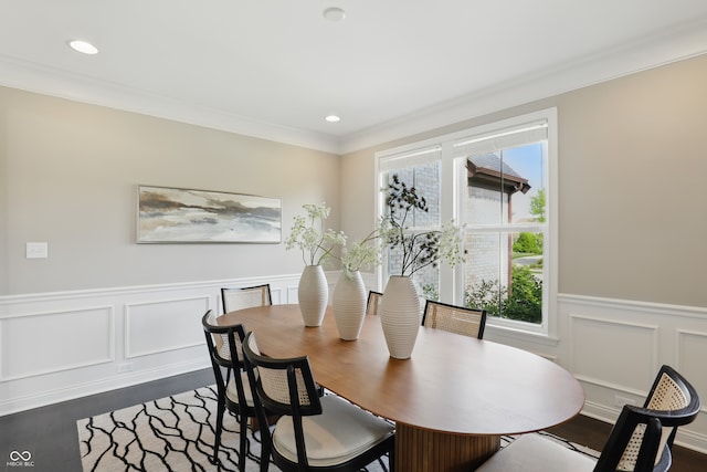 2485 Alexandra Dr, Carmel, IN 46074 - dining space featuring dark wood finished floors, healthy amount of natural light, wainscoting, ornamental molding, and a decorative wall