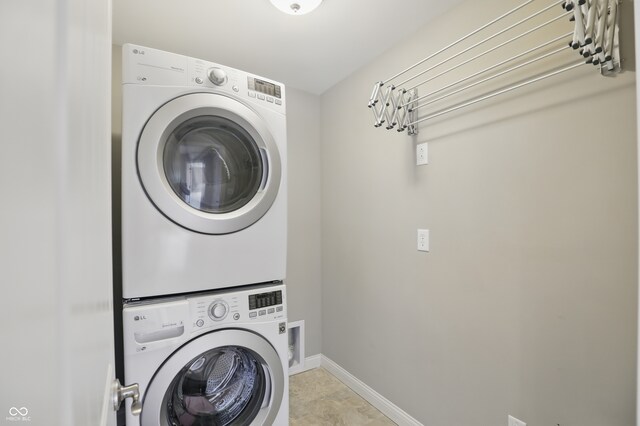 2485 Alexandra Dr, Carmel, IN 46074 - laundry room with stacked washer / dryer and baseboards
